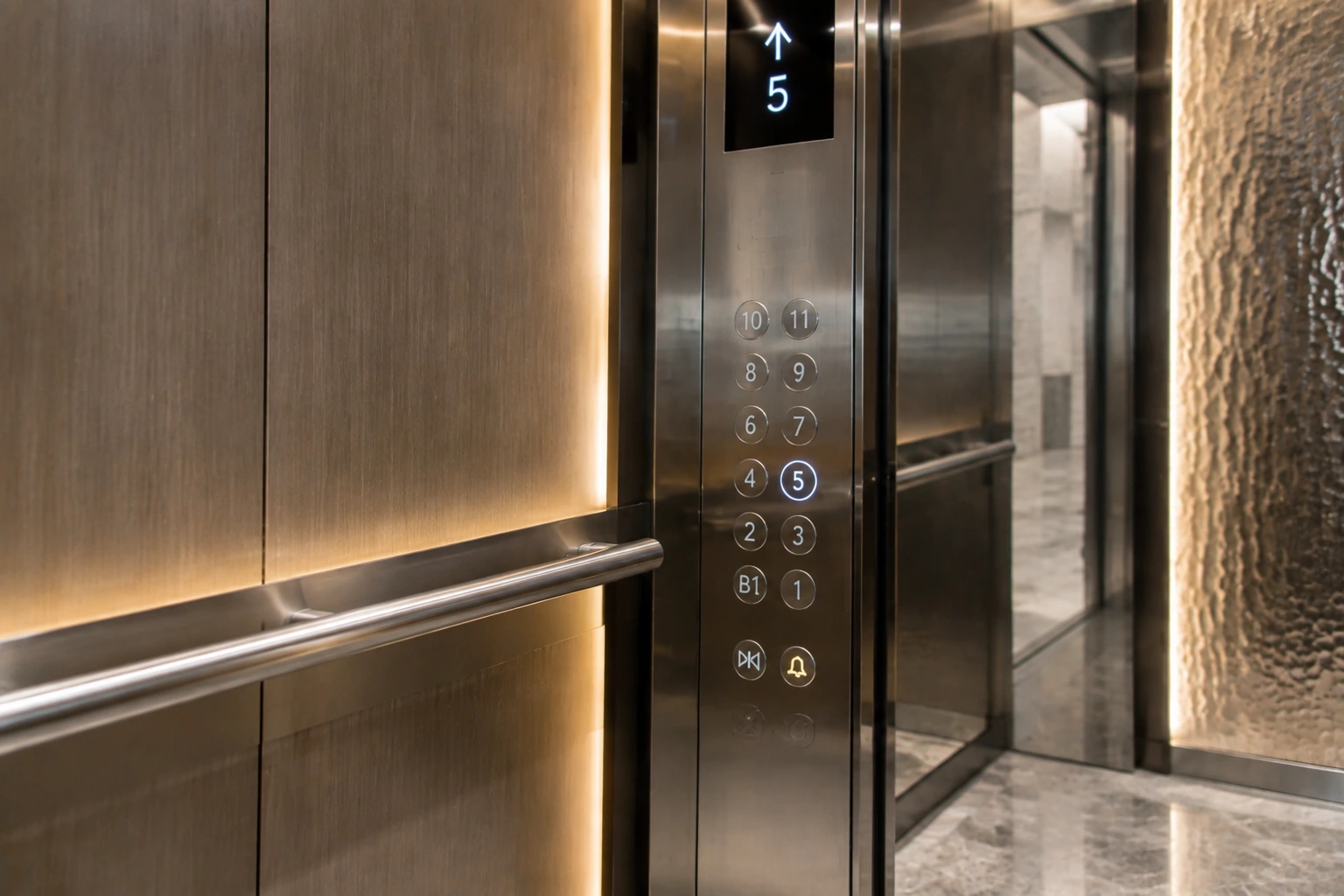 Elevator cabin with decorative metal finishes and ambient lighting